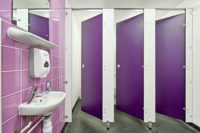 A bathroom with purple tiled walls and doors.